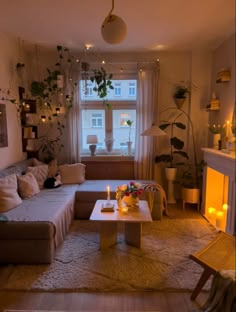 a living room filled with furniture and a fire place in front of a large window