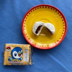 a yellow plate with a piece of cake on it next to a bag of candy