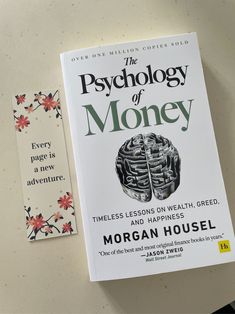 a book about the psychology of money sitting on a table