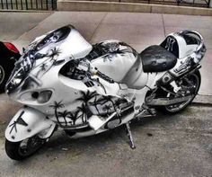 a white motorcycle with palm trees painted on it