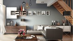 a living room filled with furniture and pictures on the wall next to a stair case