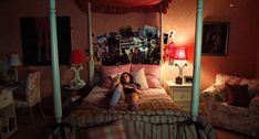 a woman laying on top of a bed in a bedroom