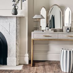 a living room with a fireplace and mirror