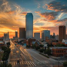 the sun is setting over a city with tall buildings