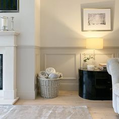 a living room filled with furniture and a fire place next to a white fireplace mantel