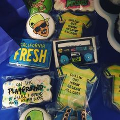 decorated cookies are arranged in the shape of t - shirts and other items for sale