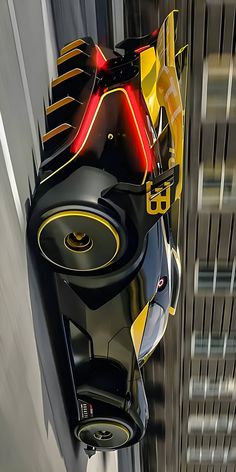 a futuristic looking vehicle is driving down the street in front of a tall building with yellow and black accents