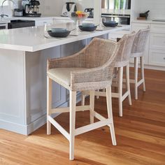 two chairs are sitting at the center of this kitchen island with an island in the middle