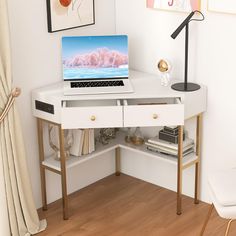 a laptop computer sitting on top of a white desk