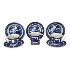 four pieces of blue and white dinnerware with an animal design on the front, set against a white background