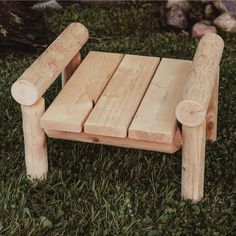 a wooden bench sitting in the grass