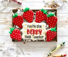 a birthday cake decorated with strawberries and the words you're the best teacher