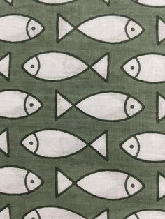 a green and white fabric with fish on it