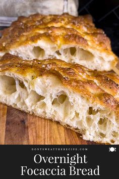 two pieces of bread sitting on top of a wooden cutting board