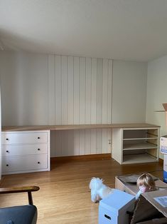 two small children are playing with boxes in the living room