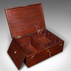 an open wooden box with compartments on the inside