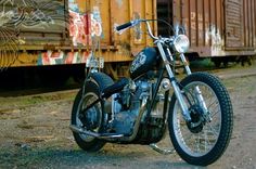 a motorcycle parked in front of a train car