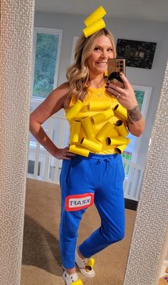 a woman is dressed up as a simpsons character and taking a selfie with her cell phone