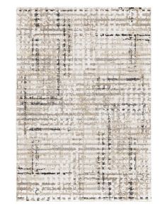 a beige rug with black and white squares on the bottom, in an abstract pattern