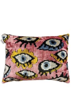 a pink and yellow pillow with eyeballs on it