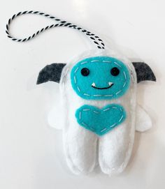 a blue and white stuffed animal hanging from a string