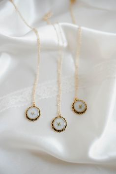 Experience the charm of a bygone era with our Clara in Winter Whites. The antique-inspired design exudes elegance with a pearl background and delicate Babies Breath accents. Embrace the old world charm and create a timeless look for any occasion. *Pressed babies breath in resin *hypoallergenic 14k gold necklace *Handmade Pearl Background, Winter Whites, Pressed Flower Necklace, Babies Breath, Baby Breath, Necklace Flower, Bygone Era, 14k Gold Necklace, Antique Inspiration