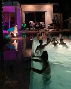 several people are in the pool at night