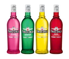 three different colored bottles of alcohol on a white background