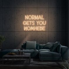 a neon sign that says normal gets you momhebe on the side of a wall