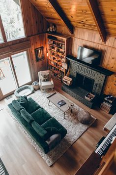 a living room filled with furniture and a flat screen tv on top of a wooden wall