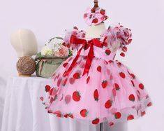 ### Product Description Our enchanting Strawberry Pattern Dress for children, crafted from luxurious tulle, satin, and organza, and adorned with delicate pearls. This knee-length dress is perfect for making your little one feel like a princess. The full set includes a beautifully designed dress, a matching headband, and a pair of red shoes.  This dress is ideal for various special occasions, including: - Birthday parties - Family gatherings - Weddings - Holiday celebrations - Photo shoots - Scho Masha And The Bear Dress Birthday, Strawberry Shortcake Dress For Baby, Pink Tulle Tutu Dress For Christmas, Red Princess Dress For Summer Party, Cute Pink Tutu Dress For Christmas, Pink Ruffled Tutu Dress For Christmas, Pink Ruffled Christmas Tutu Dress, Christmas Pink Ruffled Tutu Dress, Pink Christmas Tutu Dress With Ruffles