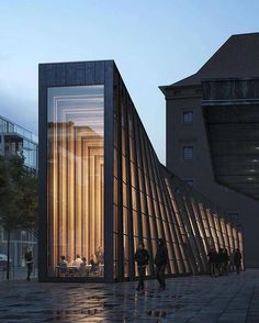 people are walking around in front of a building with vertical glass panels on the side