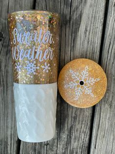 a cup that has some glitter on it next to a donut with the words winter weather written on it