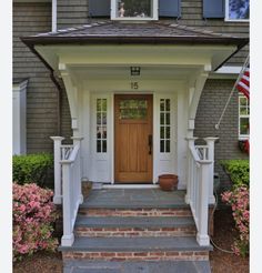 the front door of a house with steps leading up to it