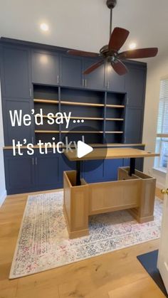 an empty room with blue cabinets and a ceiling fan that says we'd say it's trick