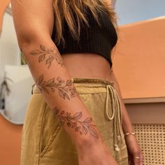 a woman with a tattoo on her arm