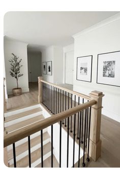 an empty room with stairs and pictures on the wall