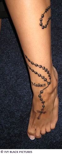 a person with a rosary tattoo on their foot