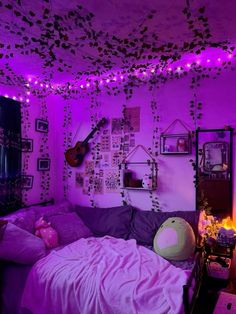 a bedroom with purple lights and decorations on the walls