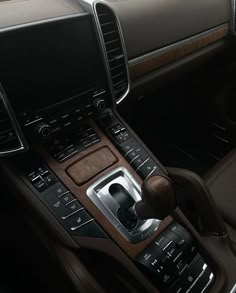 the interior of a car with an automatic gear box and steering wheel control knobs