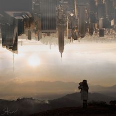 a person standing on top of a hill looking at the city skyline with skyscrapers