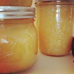 jars filled with honey sitting on top of a counter next to an orange and black object