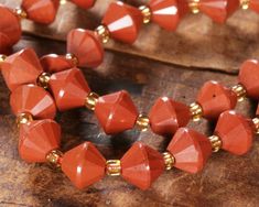 "Earthy yet vibrant terracotta color makes these beads unique and highly usable. Bicones are highly faceted from gorgeous gemstone rough, making each bead a shiny masterpiece. Bicone beads are ideal for trendy drop earrings, layered necklaces, and more. Sold as: 15-16\" strand (approximately 40 beads per strand) Red Jasper gemstone beads are named for their largely consistent coloration. Unlike many other jaspers, this stone is mostly uniform in color. These beads are red, red, and red! They often have delicate white, clear, and black veining, too. Jasper is a combination of chalcedony and quartz owing its color to iron inclusions. It has been used in jewelry and decorative arts for thousands of years. Jasper was often the stone of choice among Ancient Minoan, Egyptian, and Sasanian (Persi Ancient Minoan, Terracotta Color, Horseshoe Art, Beads Online, Bead Store, Green Opal, Shoe Art, Red Jasper, Jasper Gemstone