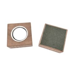 two square wooden coasters with metal rings on them, one is green and the other is brown