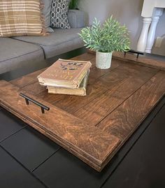 a coffee table with a book on it and a potted plant in the middle