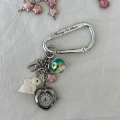 Charm carabiner inspired by one of my favorite childhood cartoons, Alice In Wonderland. ☆ Hand-dyed pink freshwater pearl stars ☆ Working watch with a battery included ☆ Double sided text * To activate watch battery, remove the white plastic on the knob and push knob inwards MATERIALS Freshwater pearls, plastic, 18K white gold plated over brass MEASUREMENTS Carabiner size: 3 x 5.5 cm