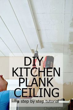 a man working on a kitchen ceiling with the words diy kitchen plank ceilinging