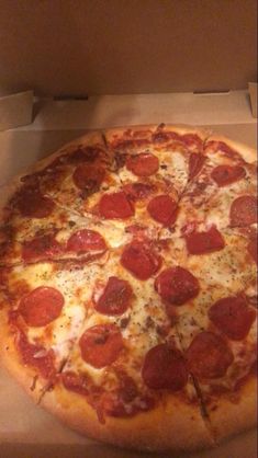 a large pepperoni pizza in a box