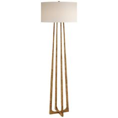 a floor lamp with a white shade on the top and two gold poles in front