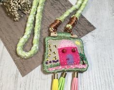 two necklaces with different designs and colors on them